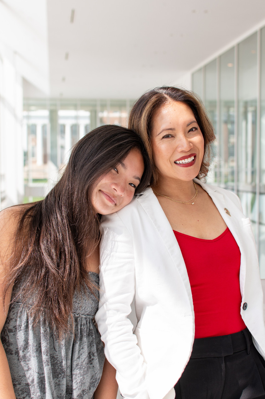 daughter rests head on mother's shoulder